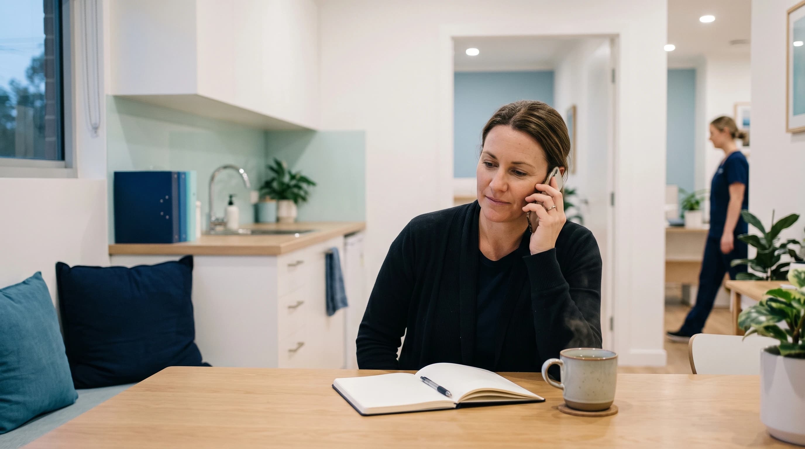 Photo of a person at home in the evening calling to book a naturopathy consult